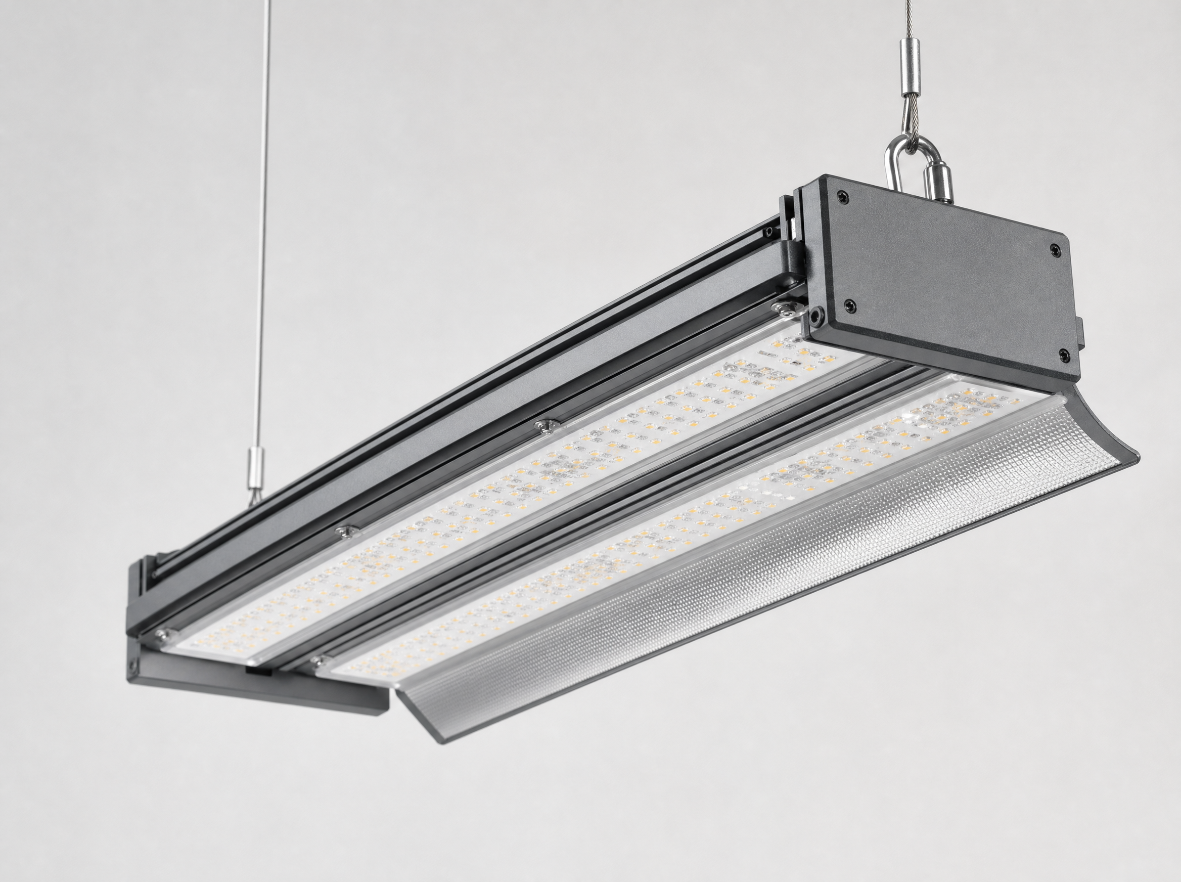 Close up of a rectangular linear 200W LED high bay light fixture with twin LED strip modules and arched reflector